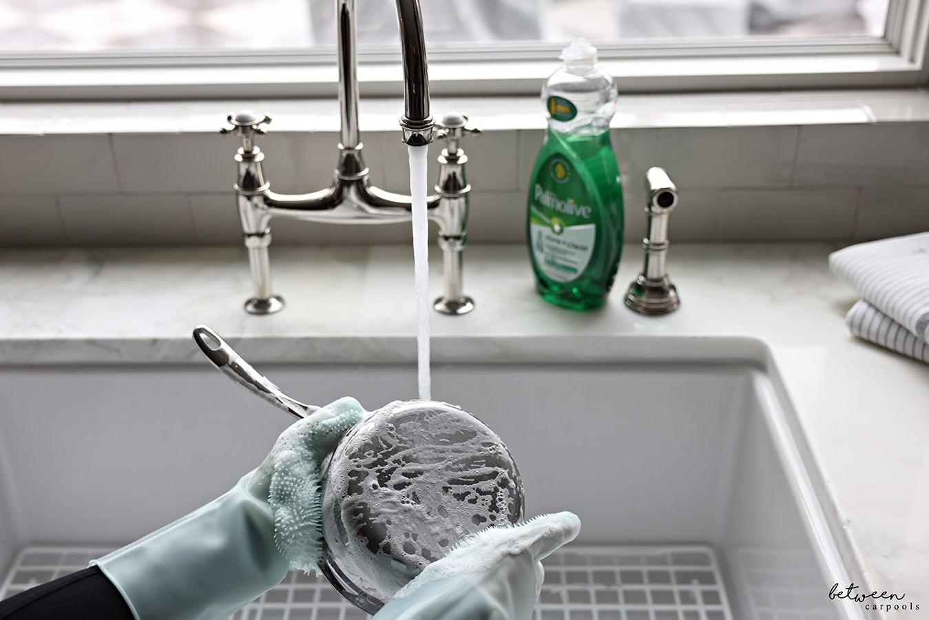 washing a pot with the gloves