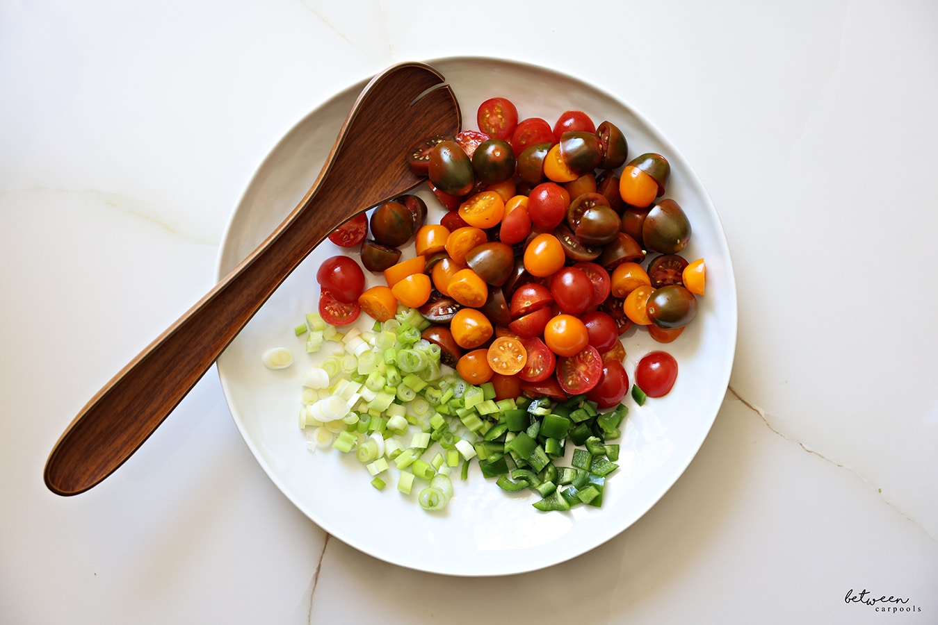 vegetables in a bowl. wooden serving spoon in the bowl