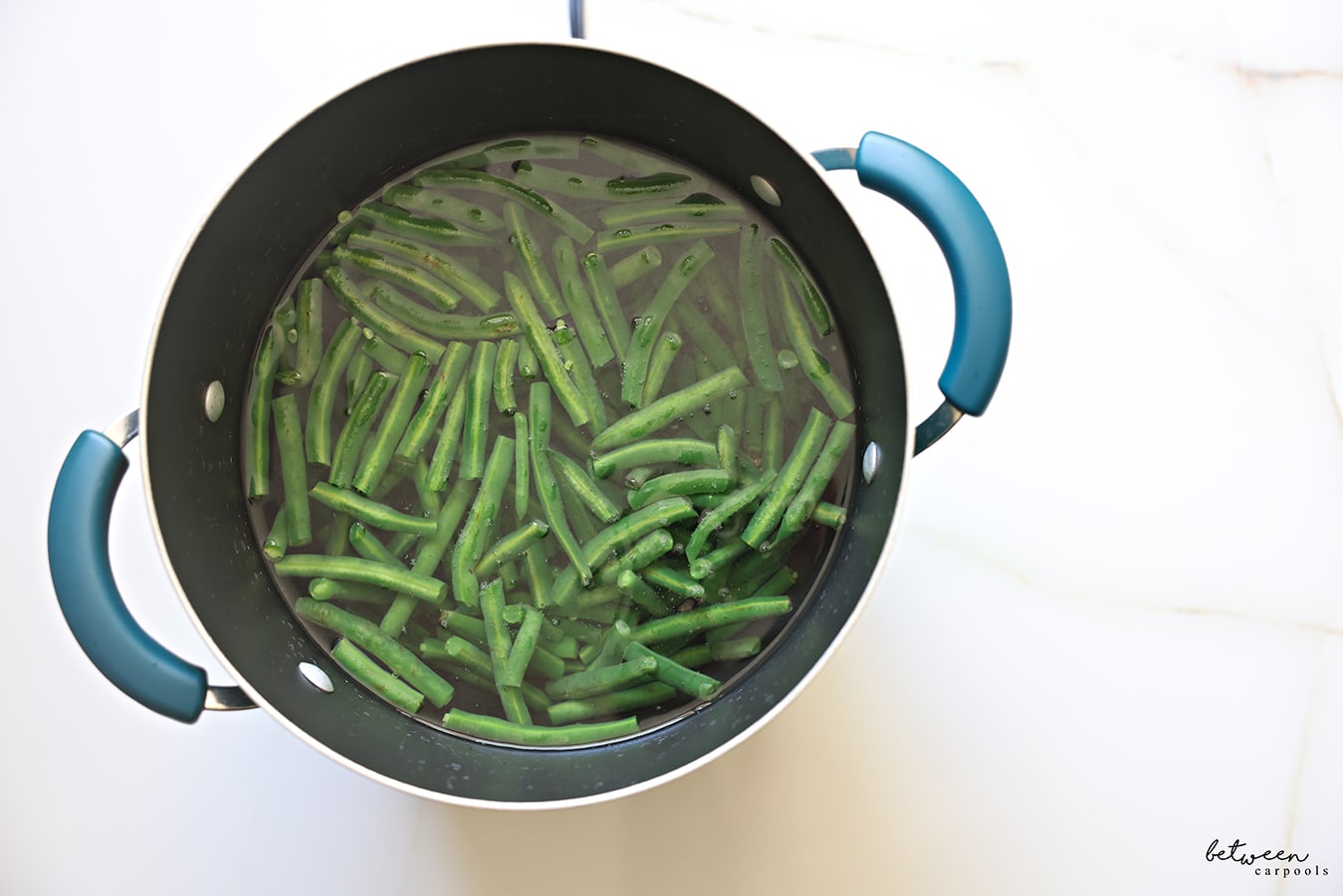Green beans in a pot of water, to be blanched.