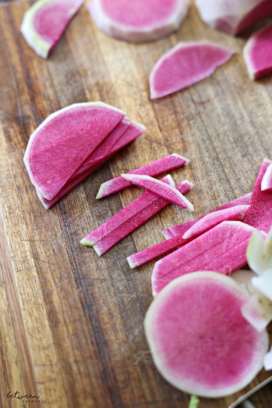 half rounds of watermelon radish cut into sticks