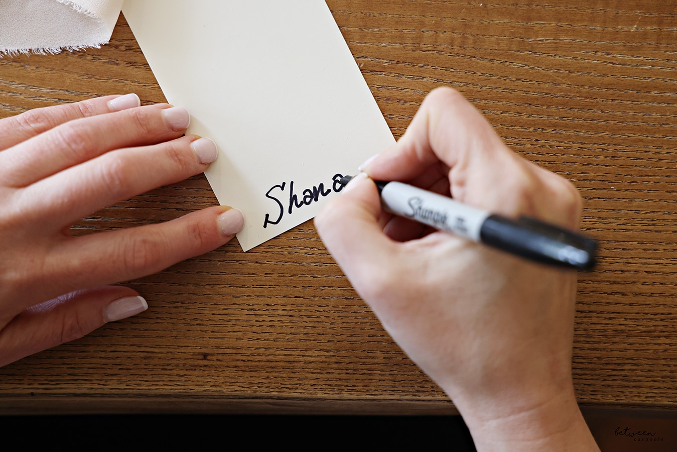 Writing names for place cards on the bottom of each card