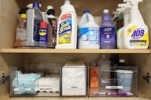 Laundry room upper cabinet with supplies and Home Edit bins