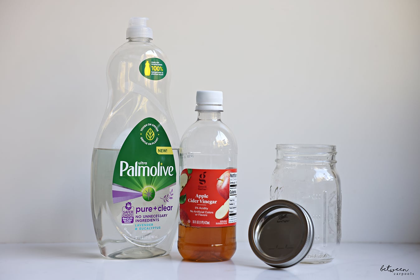 Palmolive dish soap, apple cider vinegar, empty Ball jar and cover