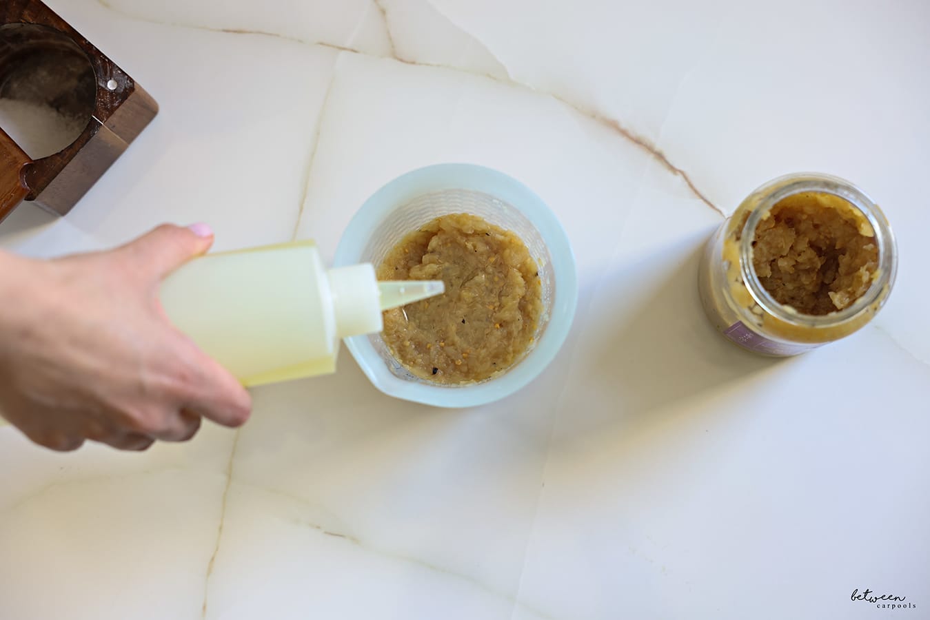 adding oil to eggplant in oxo squeeze and pour measuring cup. jarred eggplant and salt in a cellar
