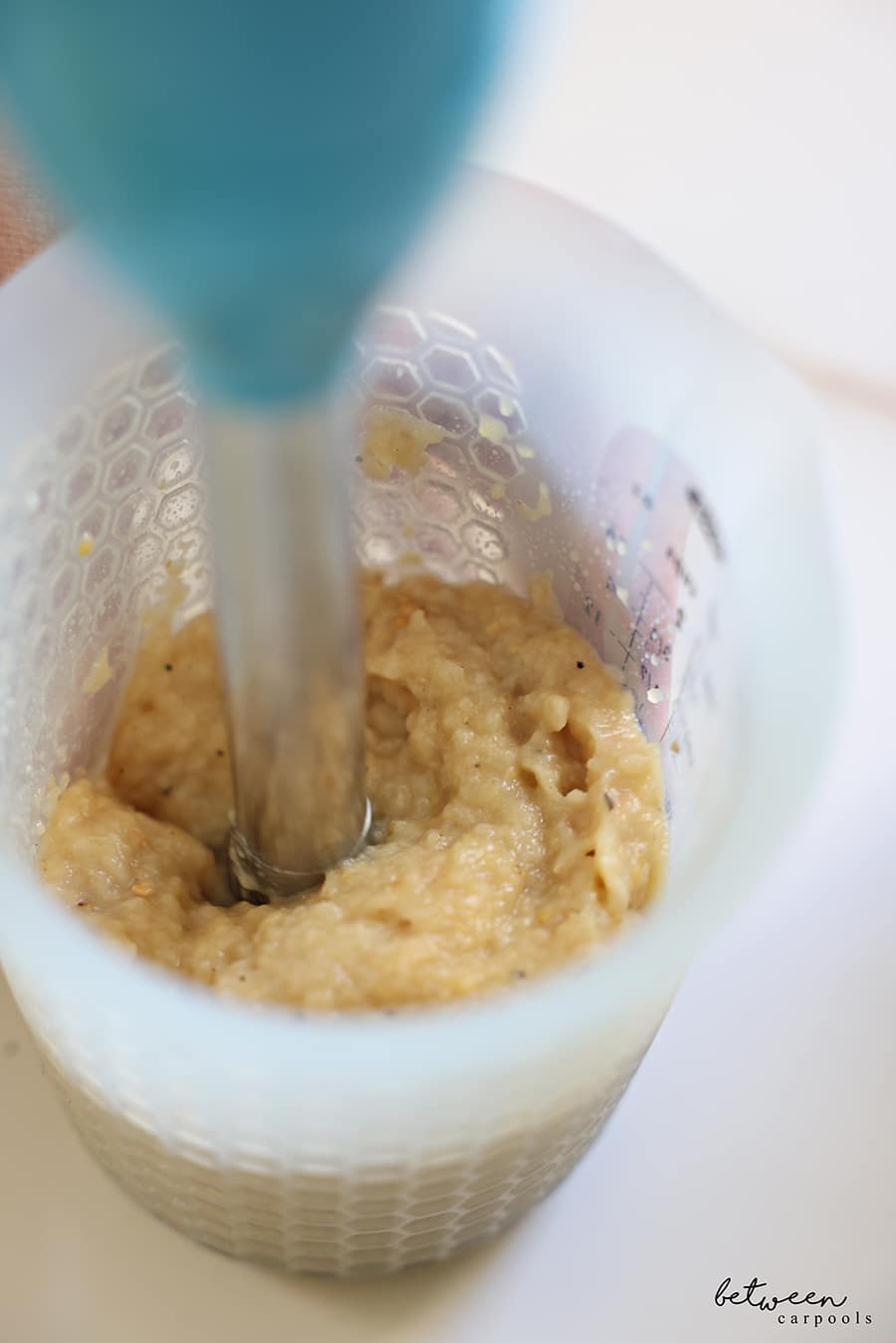 blending roasted eggplant with oil with an immersion blender in an oxo flexible measuring cup