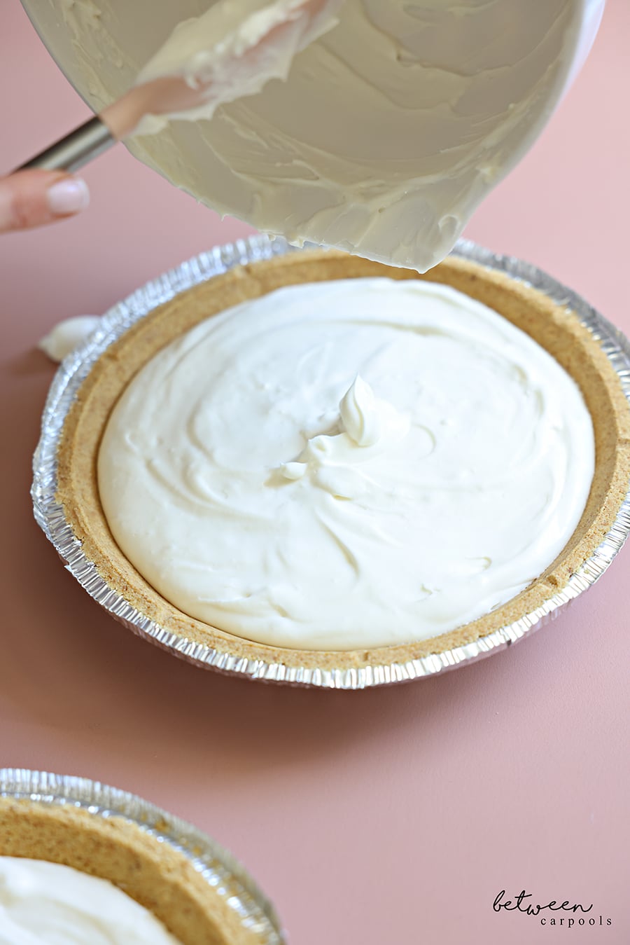 pouring cheesecake mixture into a pie shell