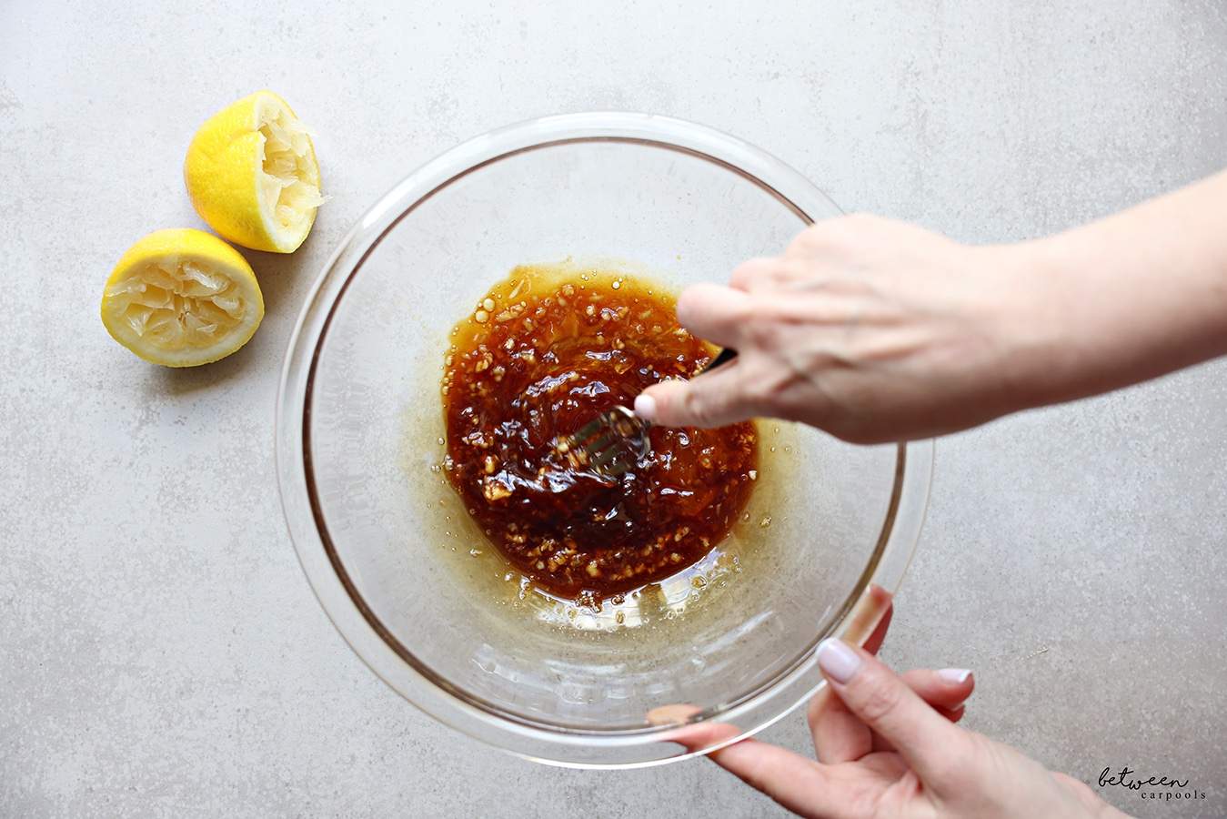 combining all ingredients for marinade in a glass mixing bowl