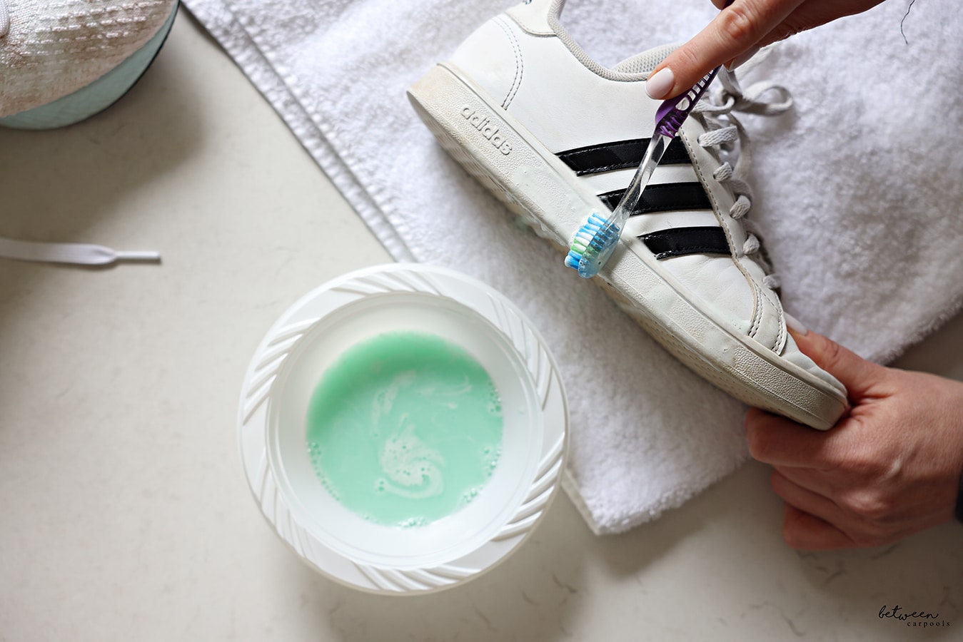 scrubbing soles of adidas girls sneaker