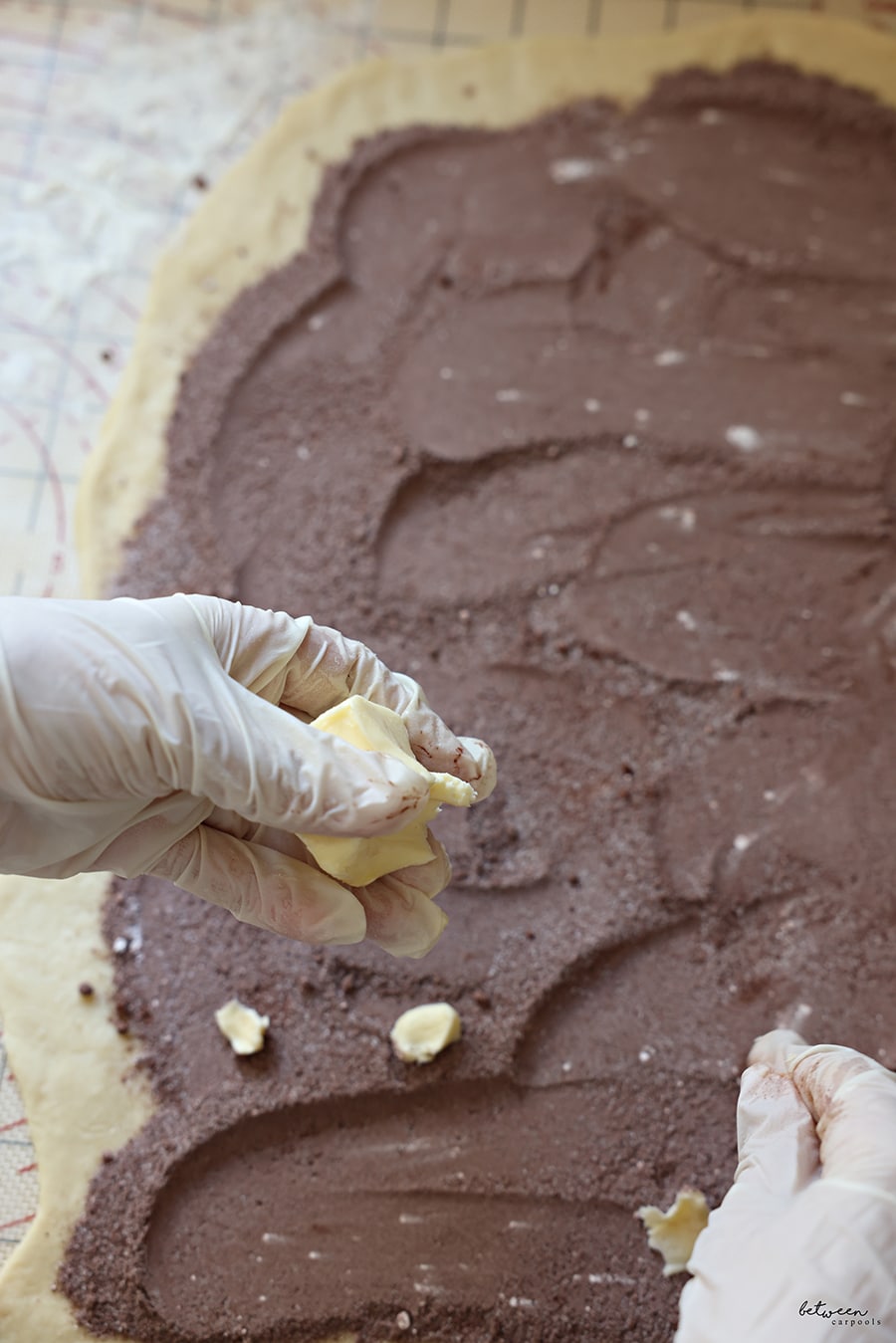 dots of butter get scattered across the rolled kokosh dough sprinkled with cocoa + sugars