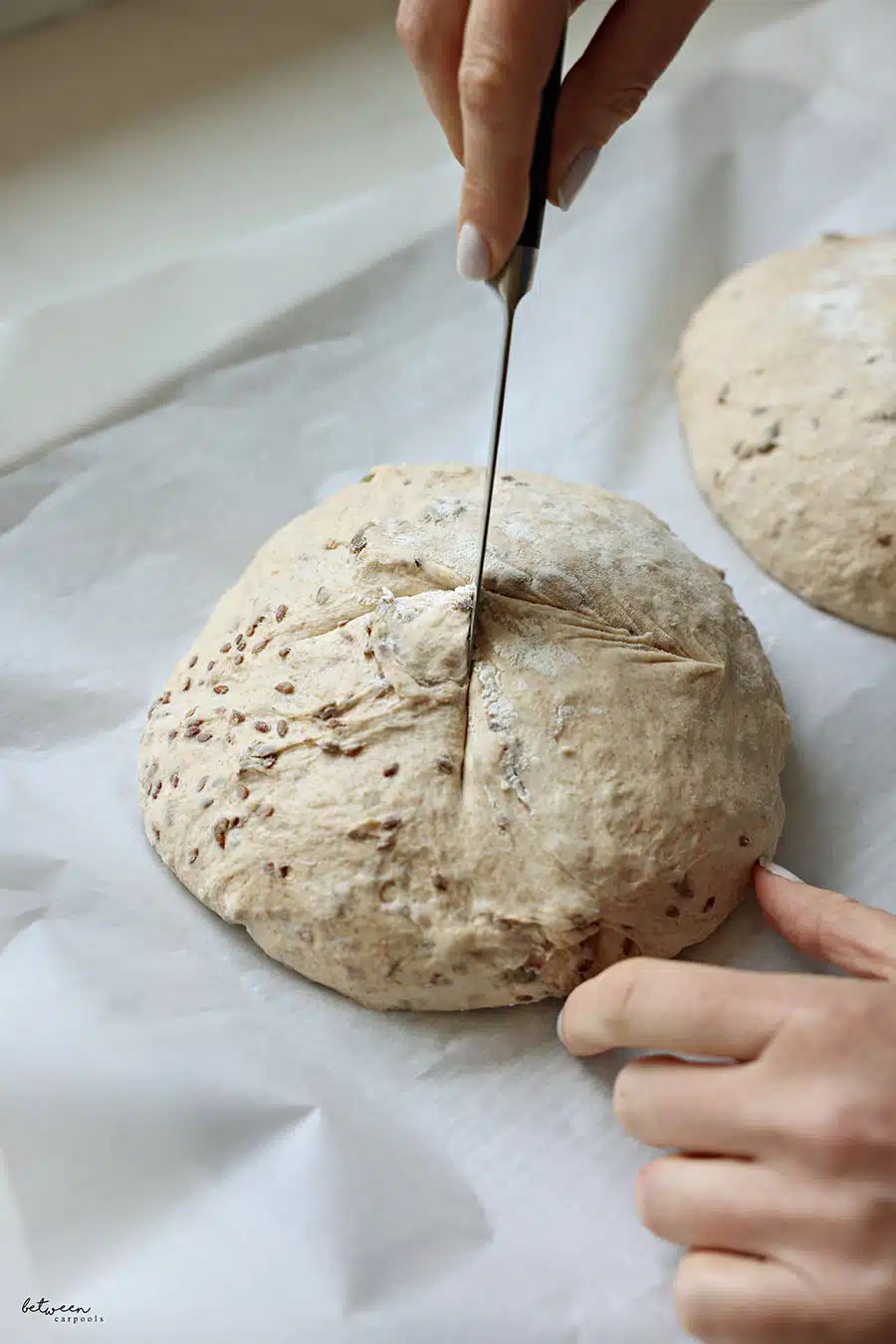 Scoring the tops of two loaves of No Knead Artisanal Bread dough