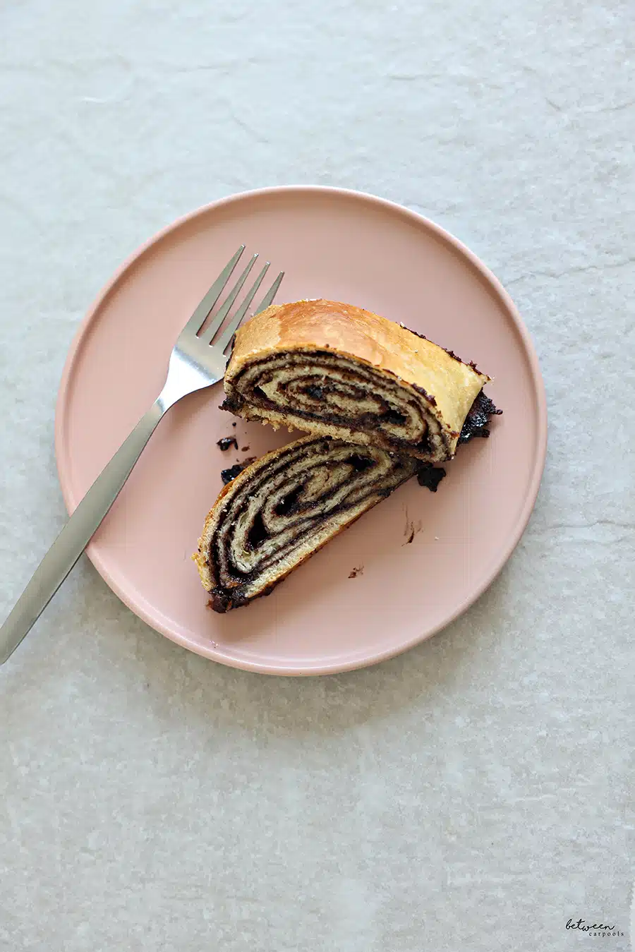 dairy kokosh cake - 2 slices on a pink plate with a fork