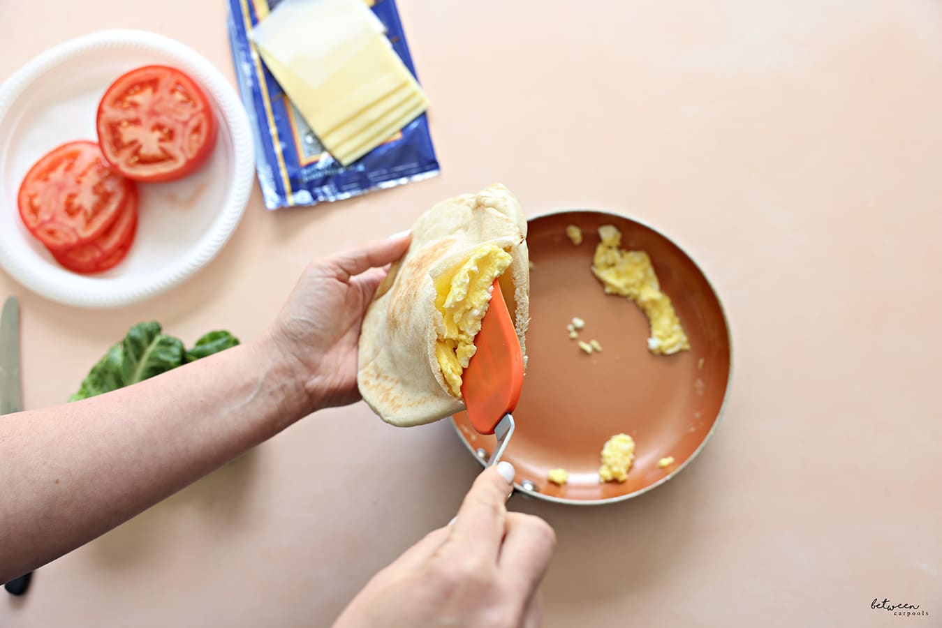 Filling a pita + cheese with hot eggs