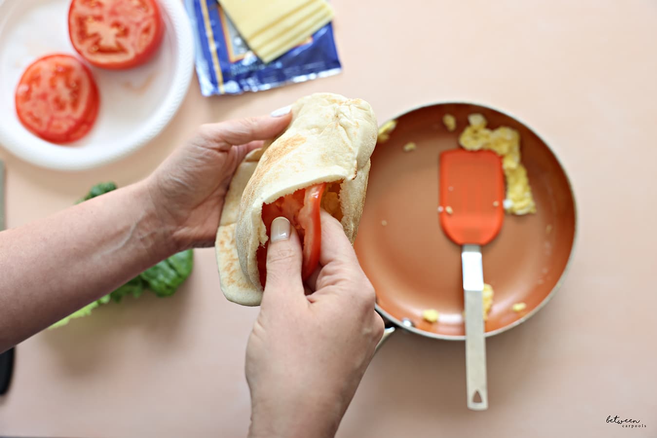 Add the tomato to your pita + cheese with hot eggs