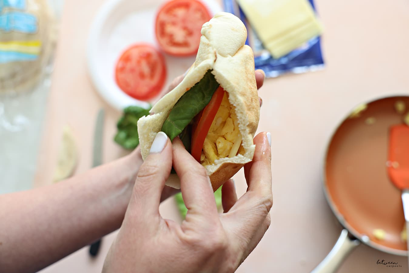 adding lettuce Add the tomato to a pita + cheese with hot eggs
