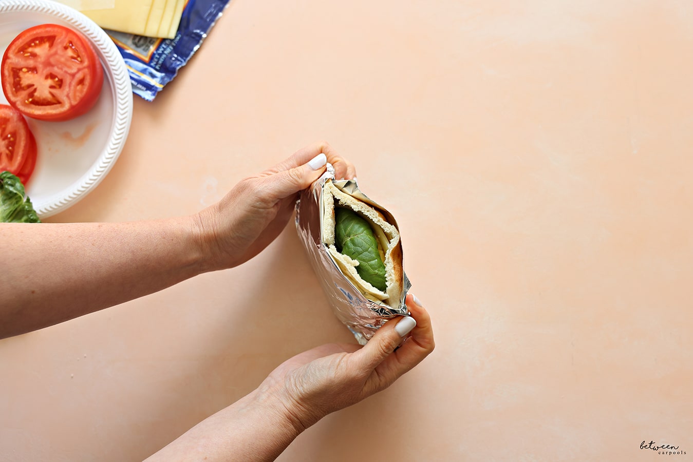 Holding a pita wrapped in foil