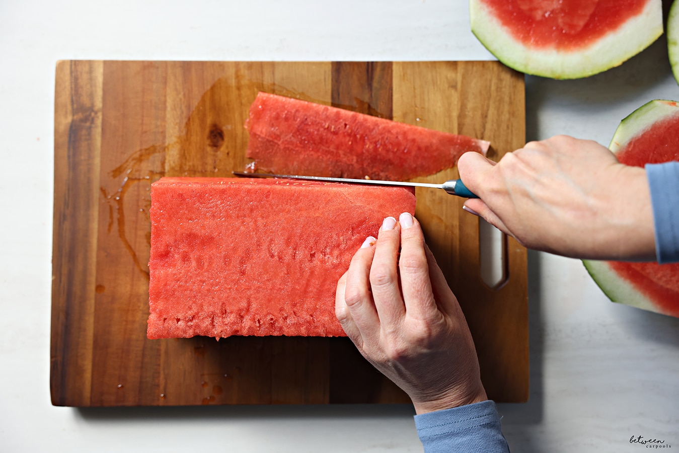 watermelon cut into a rectangle and cutting off the rind