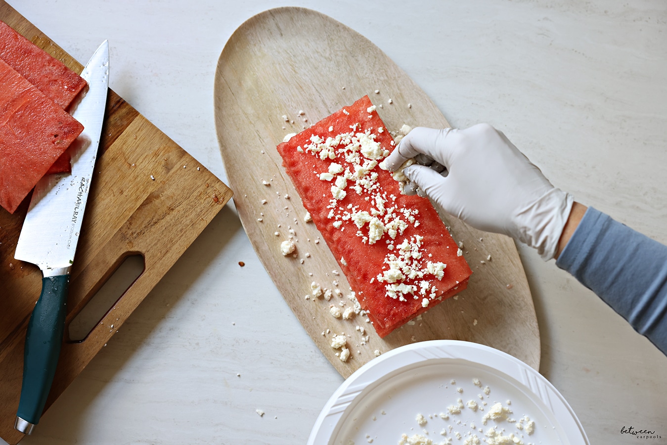 Adding crumbled feta as a layer to the watermelon and feta cake