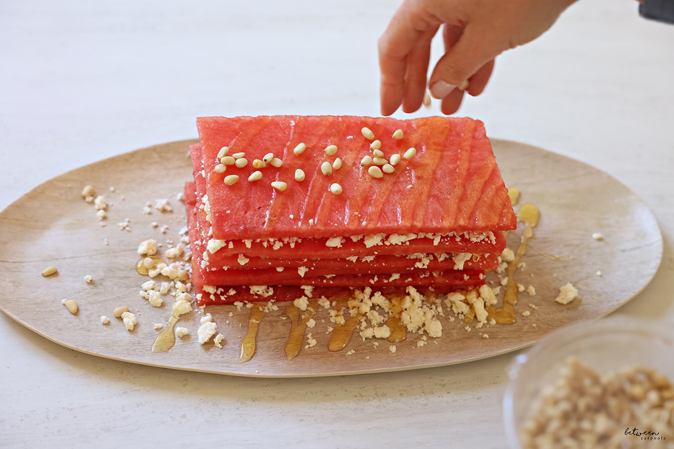 Watermelon and feta topped with honey, and some nuts.