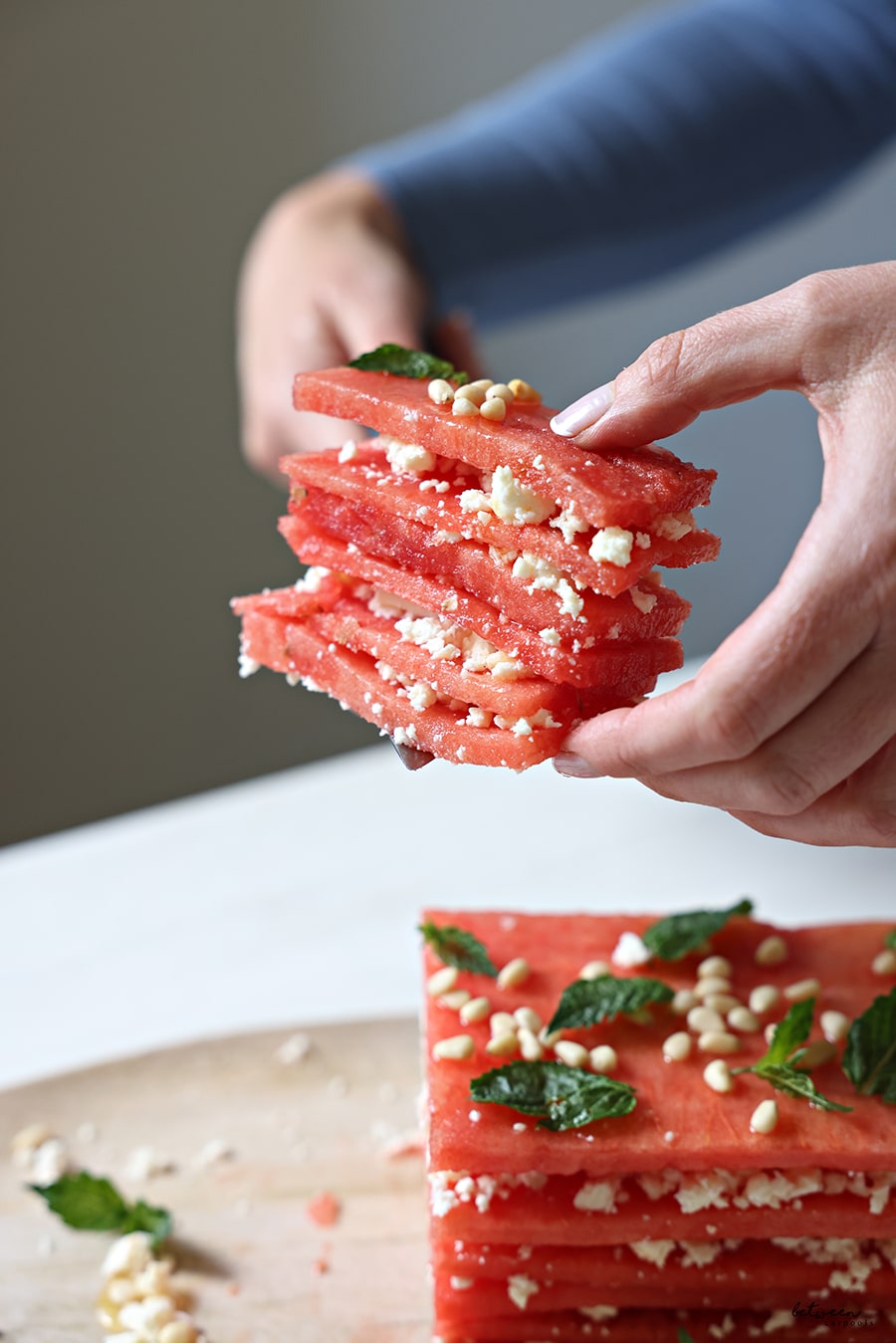 Holding a slice of watermelon and feta cake
