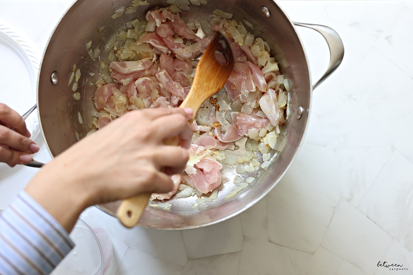 After sautéing the onion, garlic, and chicken, stir in the rice and let it toast for a minute. 