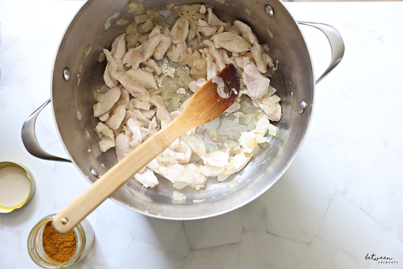 After sautéing the onion, garlic, and chicken, stir in the rice and let it toast for a minute. 