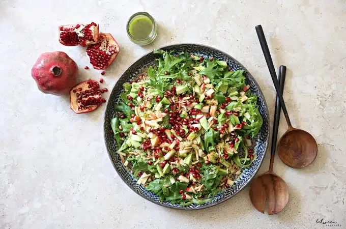 Plated salad, and a small jar of dressing nearby.