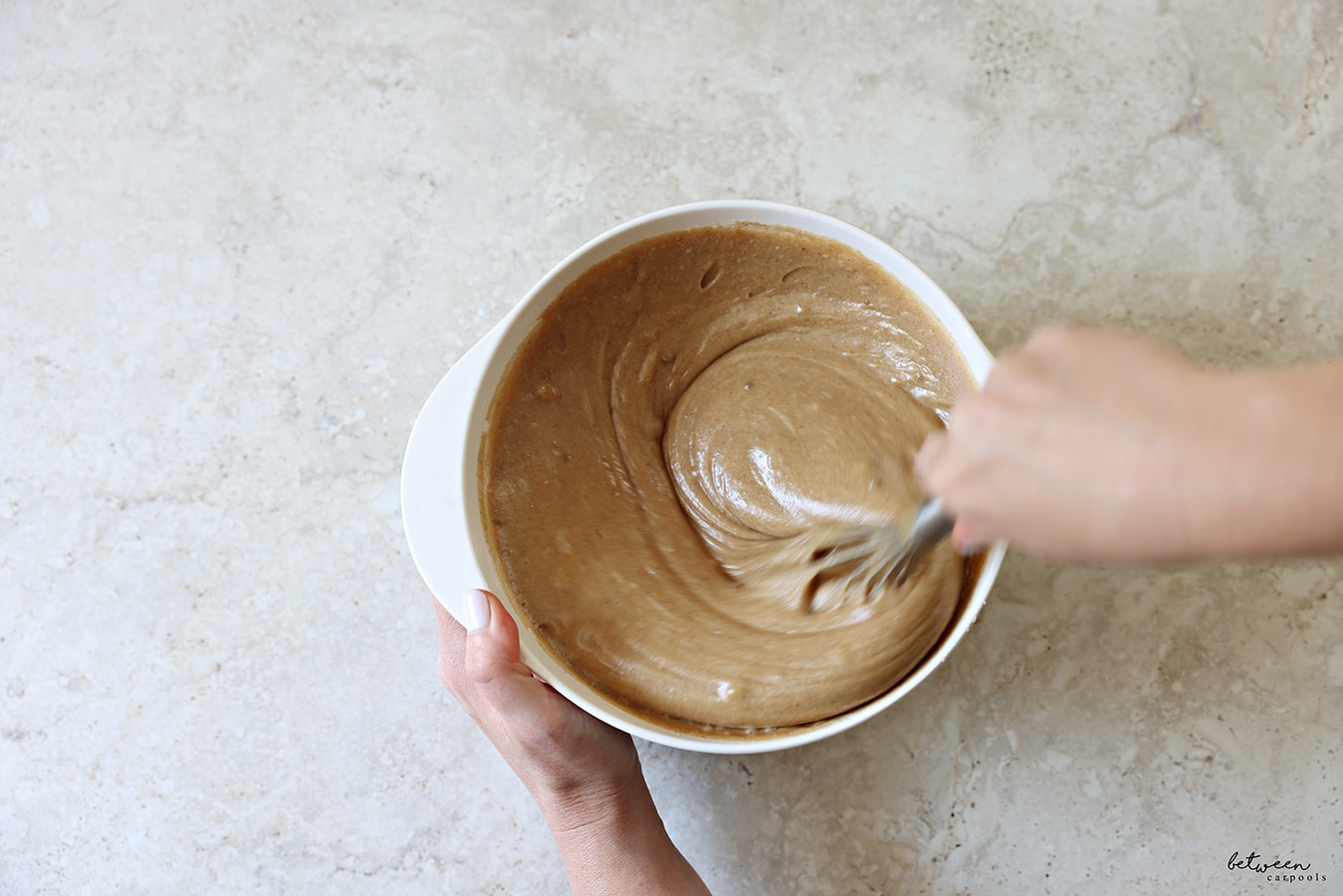 Mixing all wet ingredients with the dry ingredients with a whisk