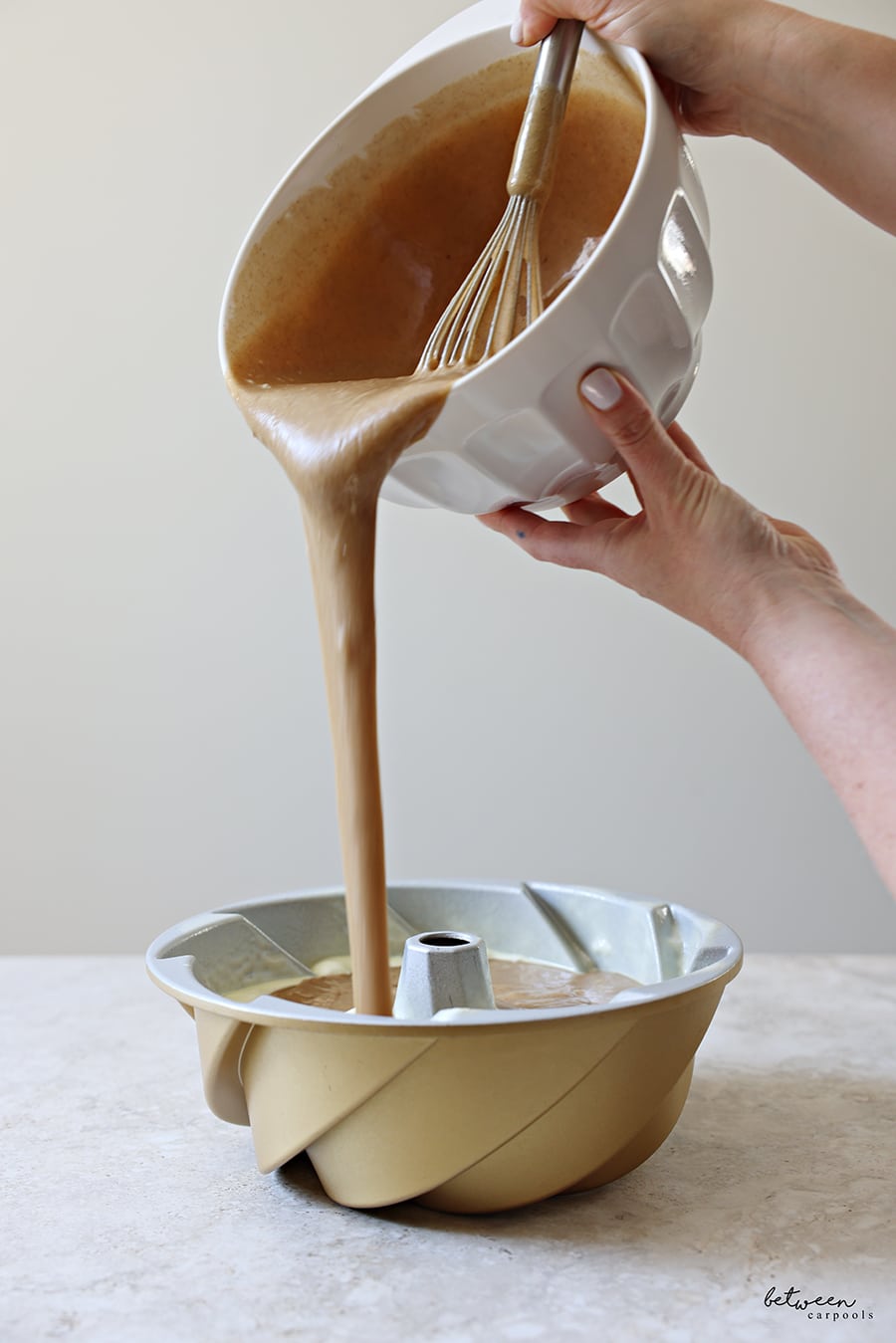 Pouring the batter into the greased bundt pan.