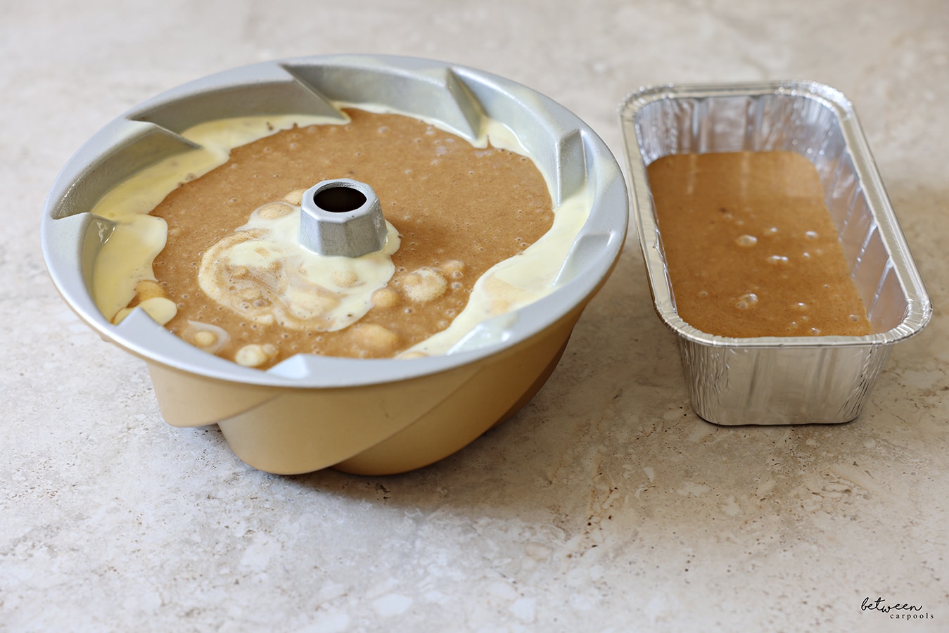 honey cake batter in a 10 cup bundt pan + one small loaf pan