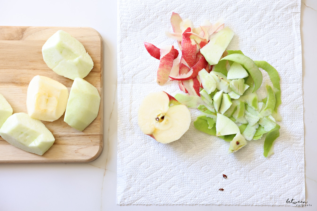 Peeled apples. Some on a cutting board, half an apple on a paper towel with apple peels