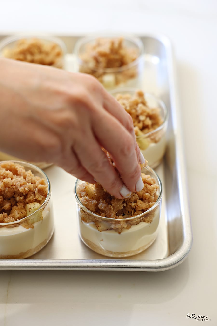 The with streusel over the apples in each ramekin