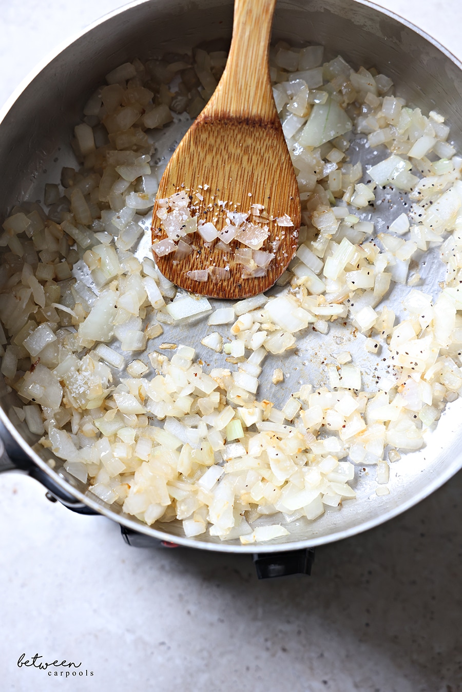 Sautéing diced onion in a pan.