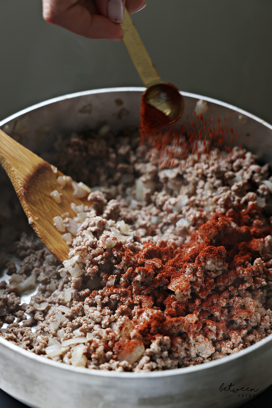 Seasoning ground beef mixture in sauté pan.