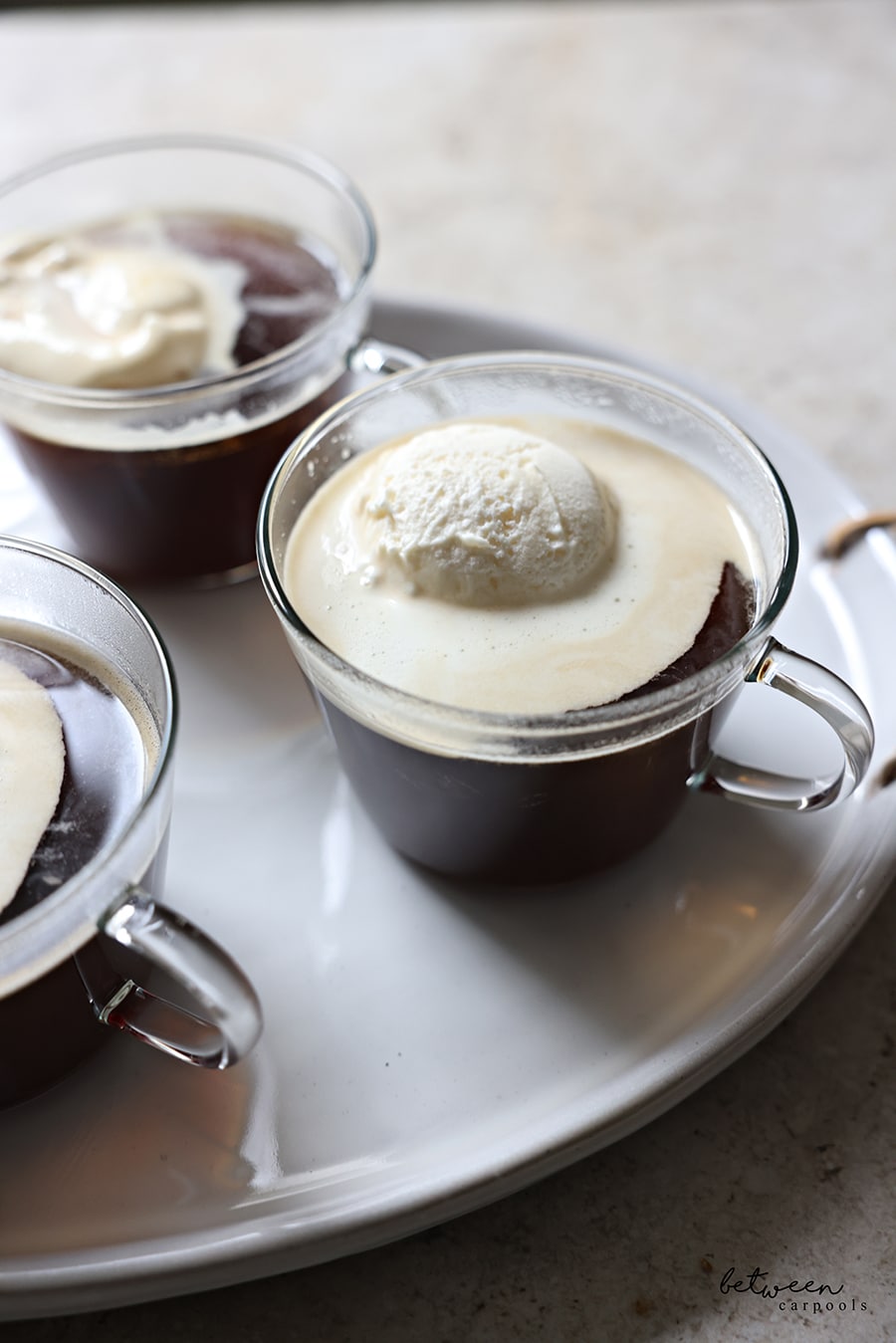Closeup of affogato coffee dessert in glass teacups on a tray.