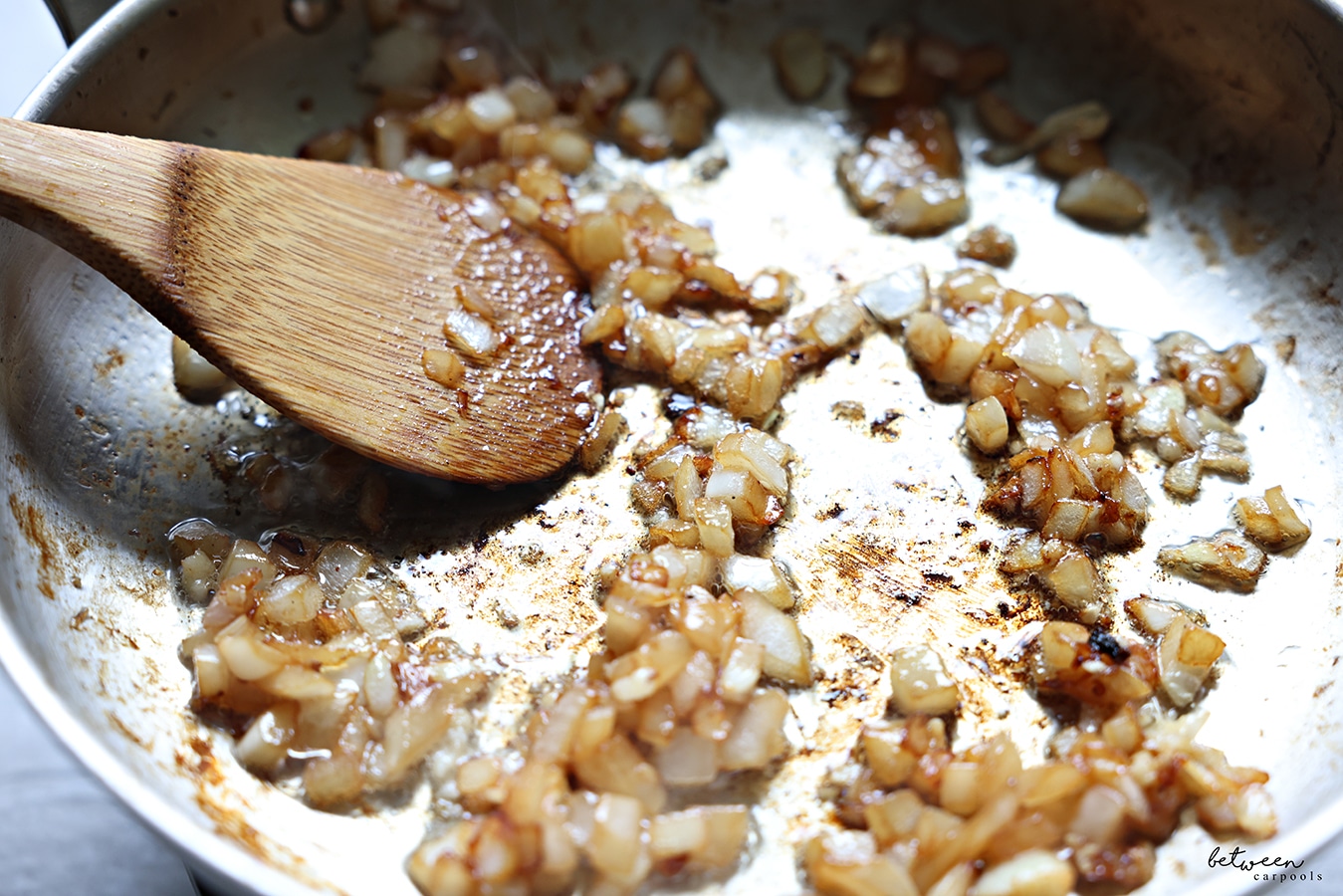 mushrooms and onions sautéing in a pan.
