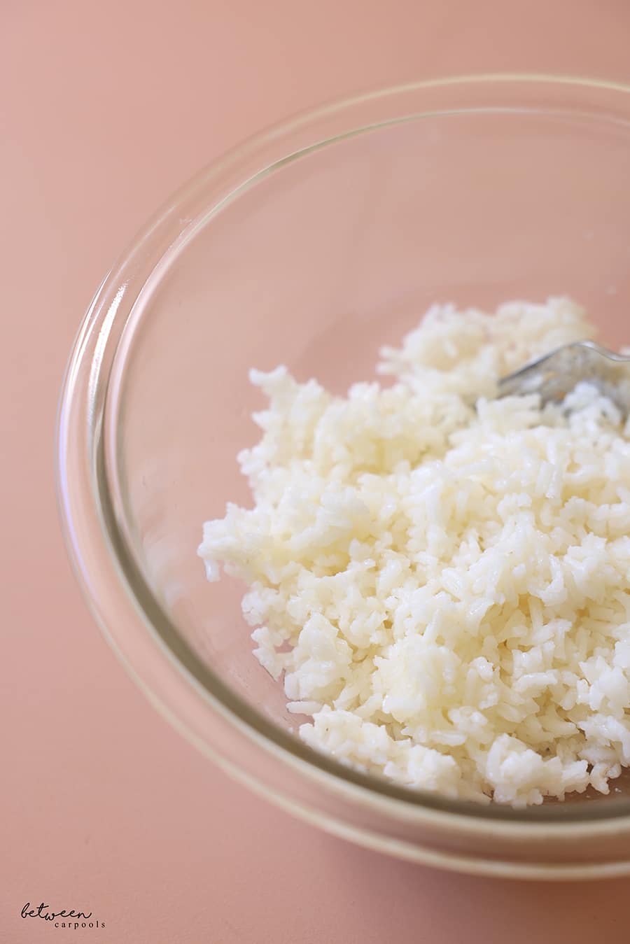 Prebaked and frozen rice, reheated in a microwave safe glass bowl.