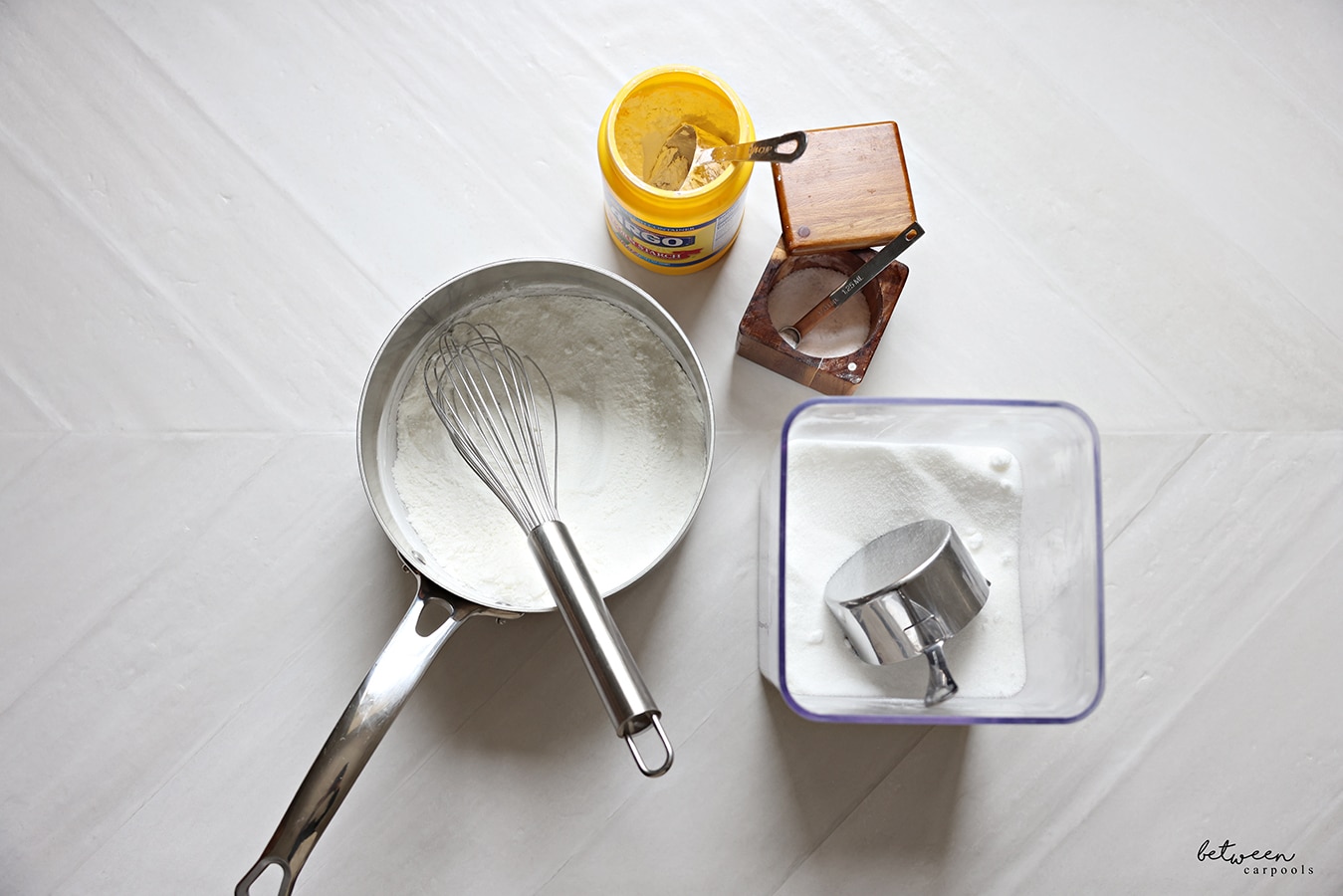 Ingredients and a pot plus whisk for lemon curd.