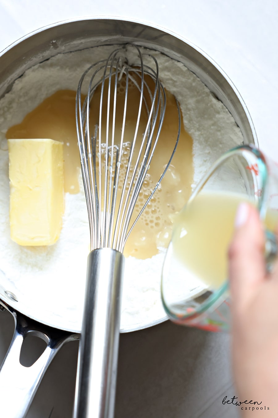 Adding lemon juice to whisked sugar, cornstarch, and salt, and margarine. 