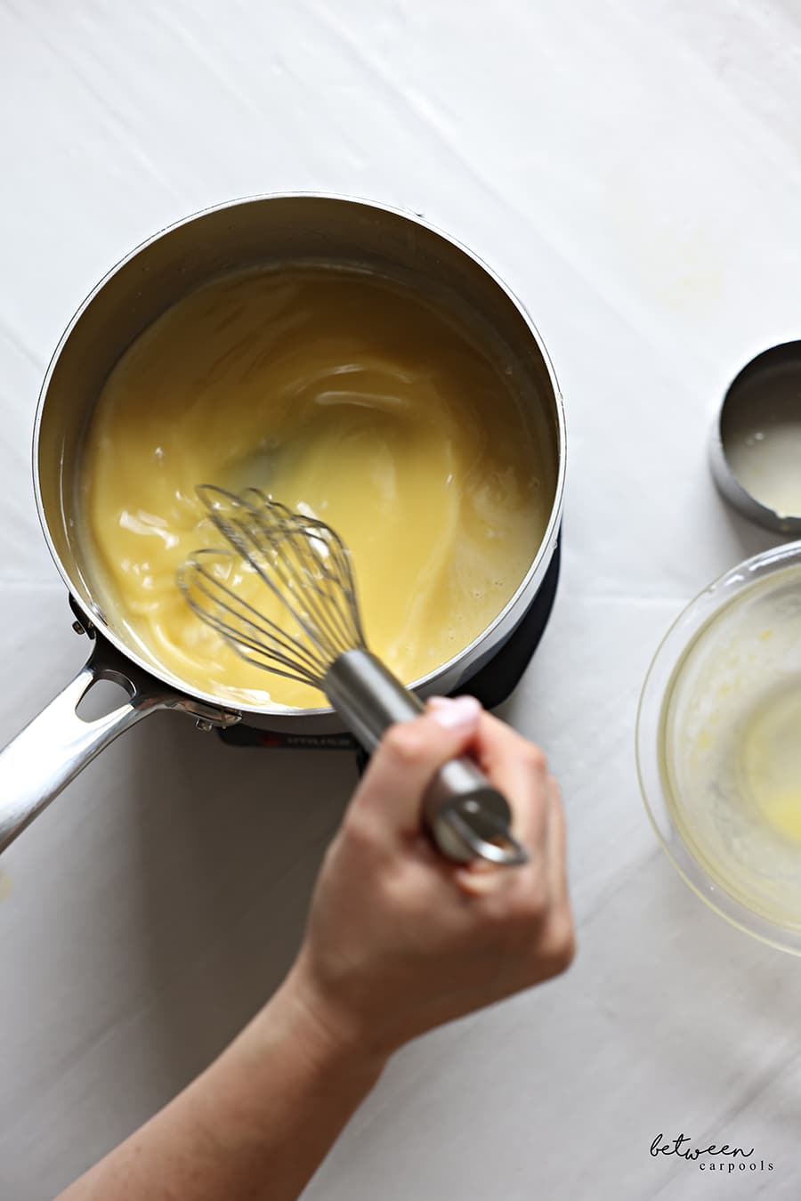Whisking the egg mixture added to the pot with curd.
