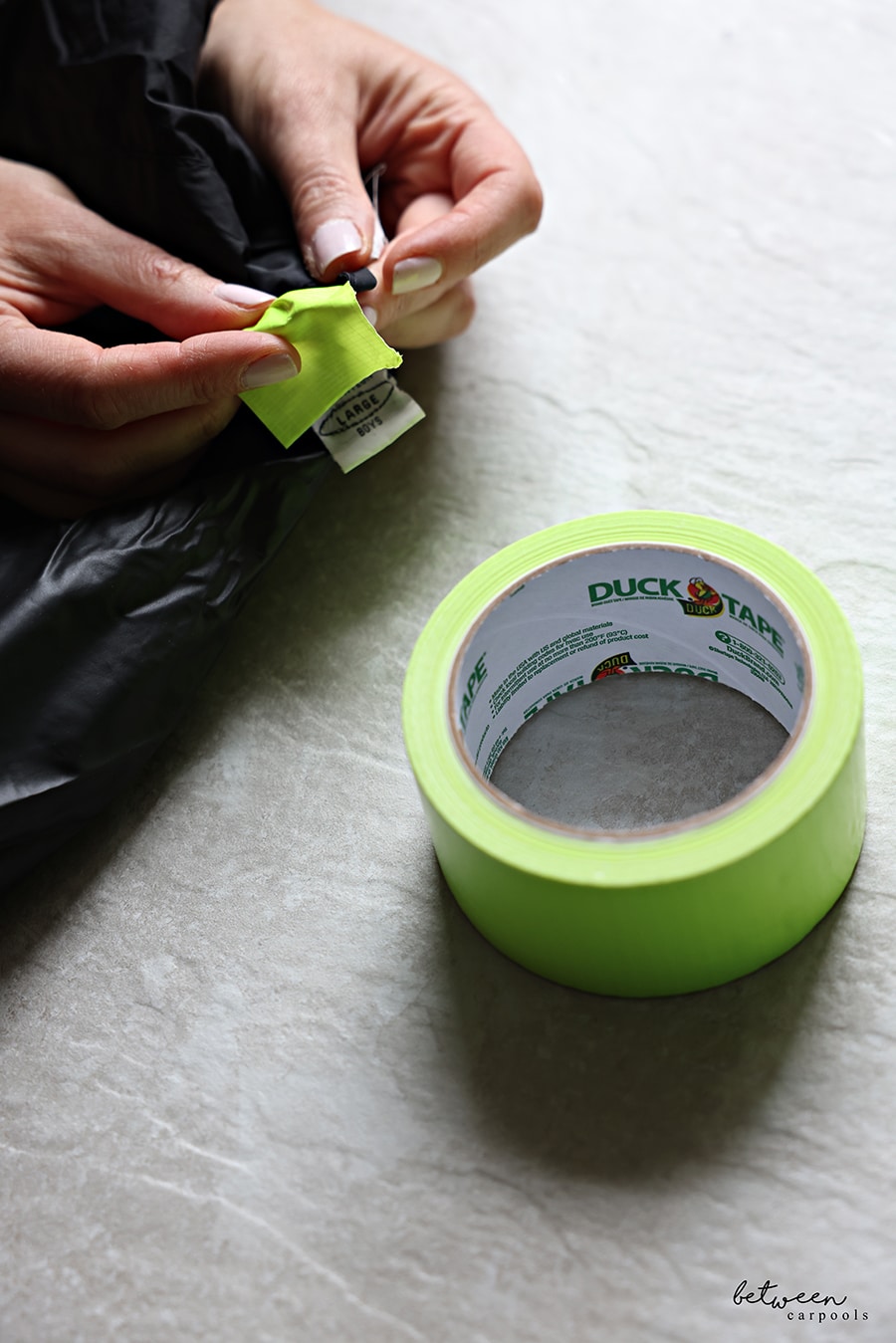 adding duck tape to a coat loop