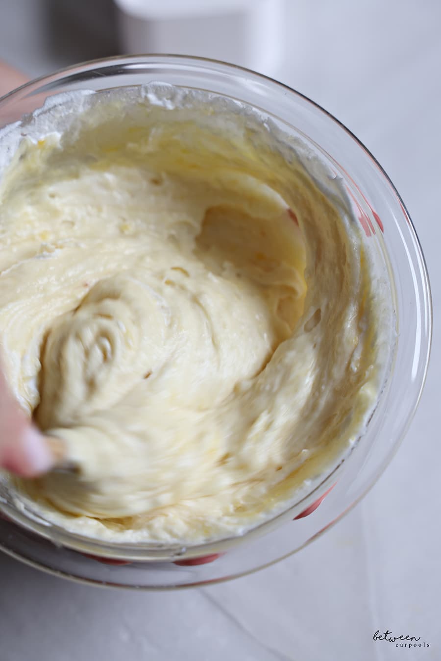 Folding some whipped topping into the cooled curd.