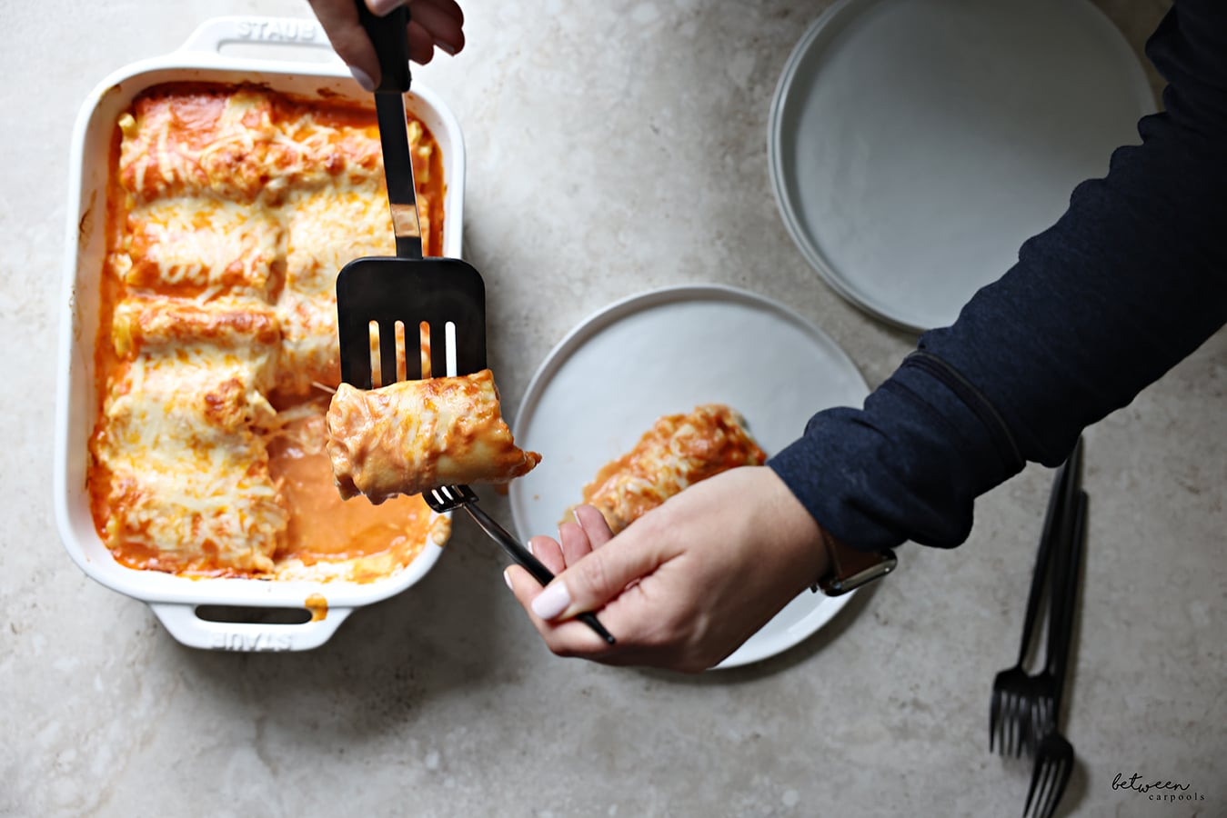 Serving and plating Lasagna Roll-Ups from a Staub baking pan.