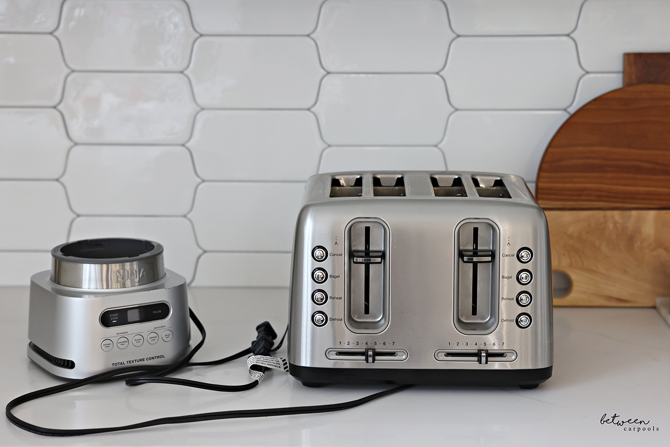 Toaster and Ninja smoothie machine on kitchen counter.