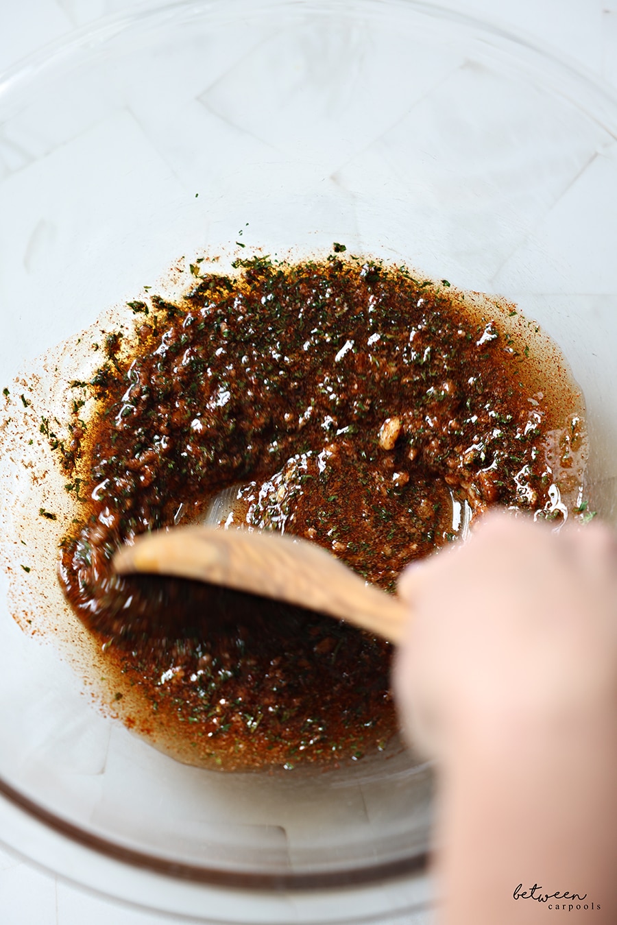 Mixing all the other ingredients in a bowl with a wooden spoon.