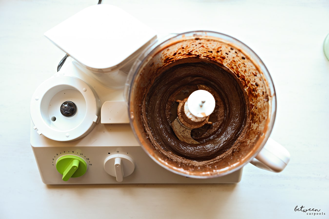 Chocolate, puréed with boiling water, in the bowl of a food processor fitted with the “S” blade.