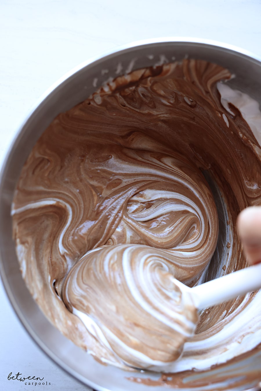 Carefully folding the chocolate mixture and stiff egg whites together - in the bowl of a Kitchen Aid mixer.