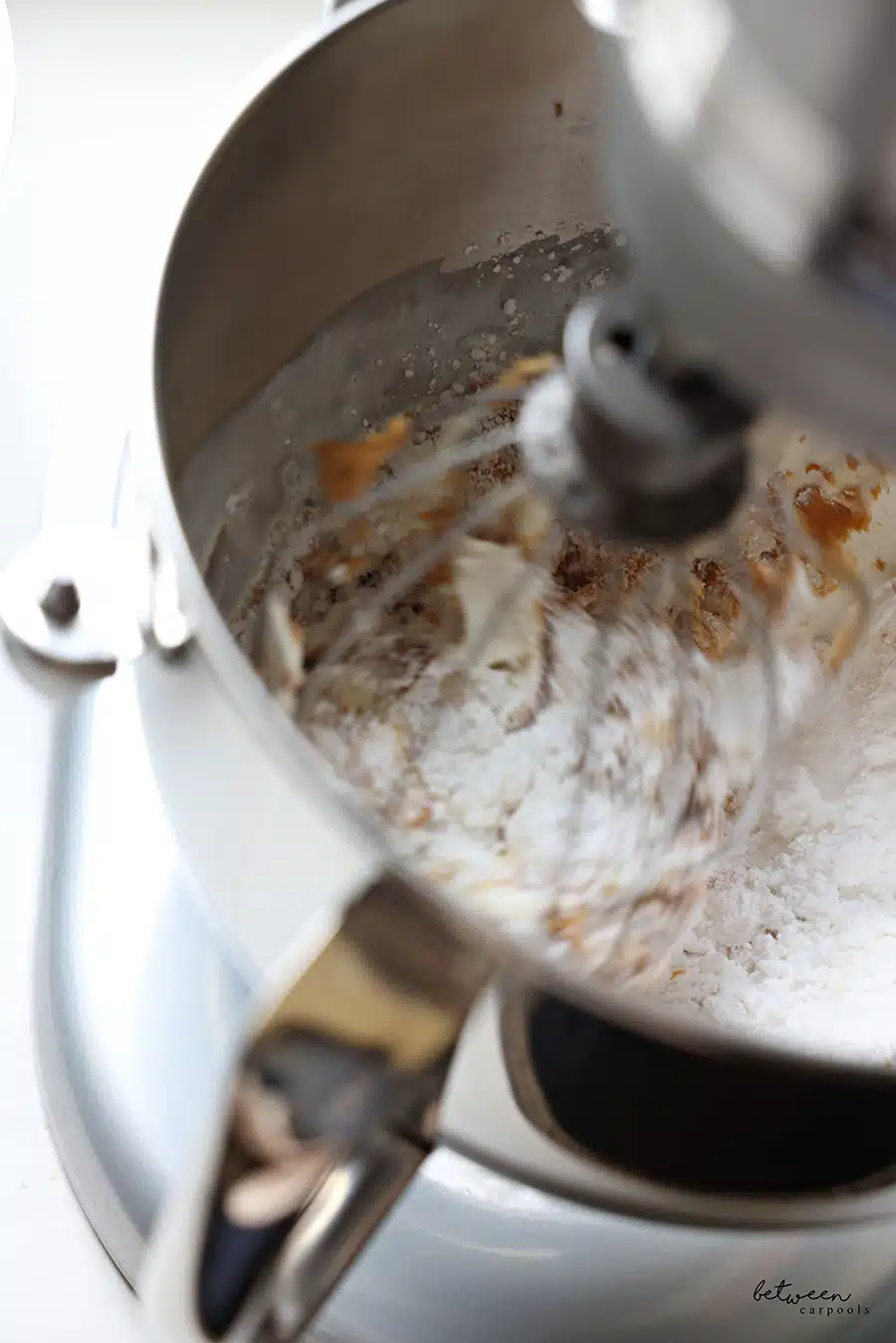Mixing the confectioner's sugar, peanut butter, pareve cream cheese, and whipping cream.