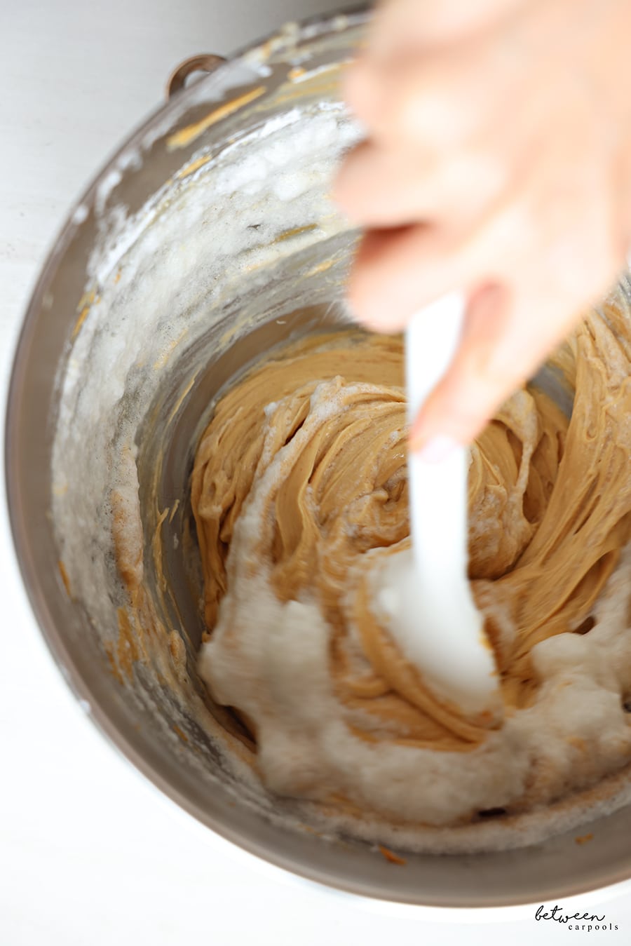 Folding the egg whites into the peanut butter mixture.