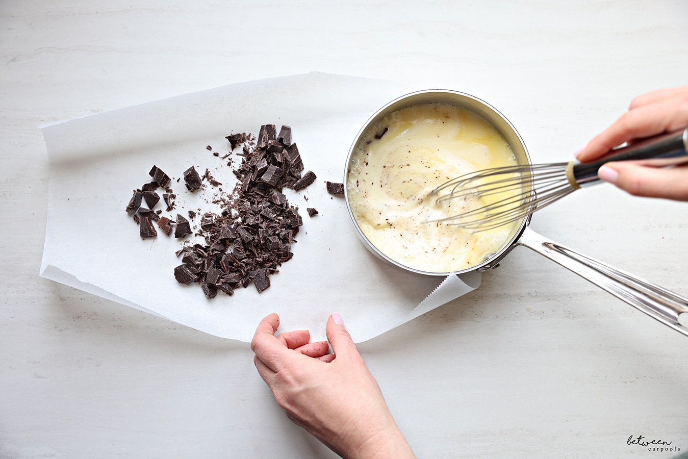 Whisking simmering whipping cream and margarine in a small saucepan.