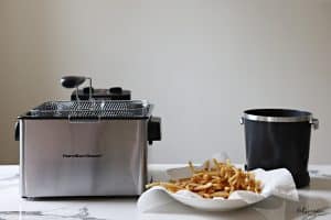 Hamilton Beach Electric Deep Fryer, FryDaddy Electric Deep Fryer and French fries in a paper towel lined bowl.